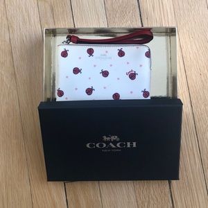 White Coach wristlet with red ladybugs